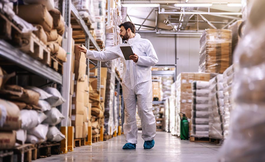 An image of a warehouse operator inspecting inventory