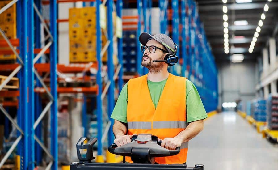 An image of a warehouse operator using voice picking technology