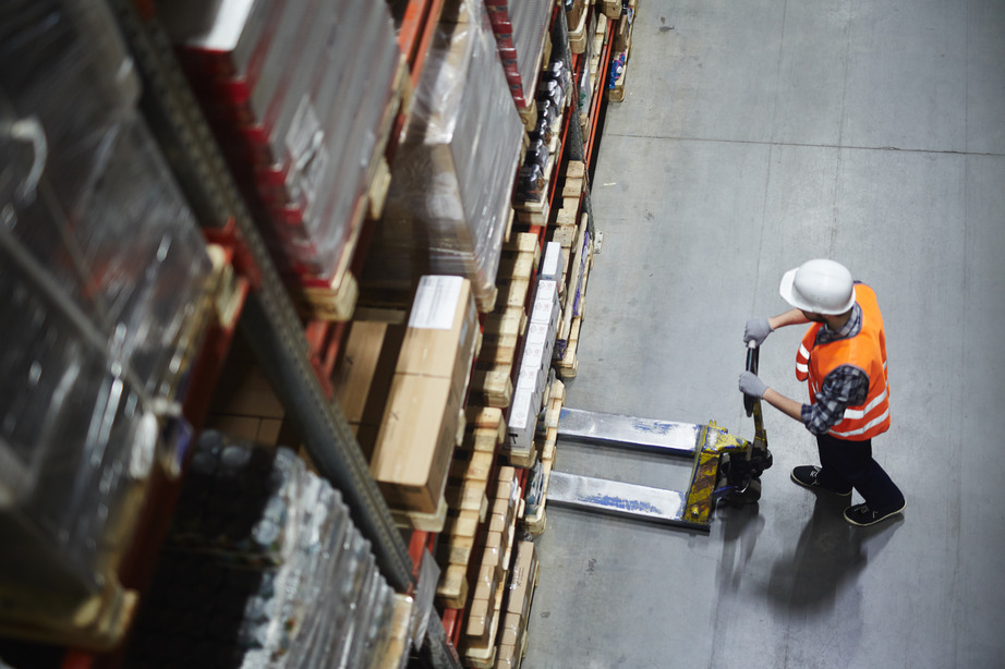 A warehouse employee using a forklift