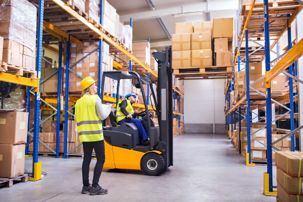 A warehouse employee using a forklift​