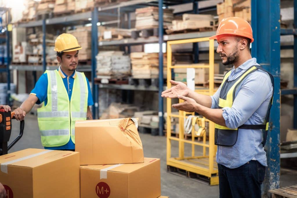 A warehouse manager is disappointed because of a damaged box​