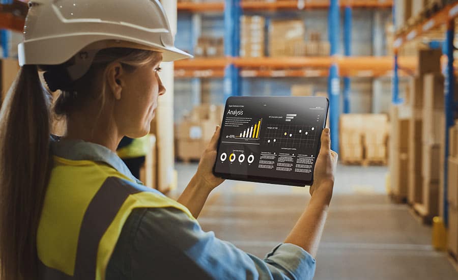 An image of a warehouse employee using a tablet showing Automation in Production