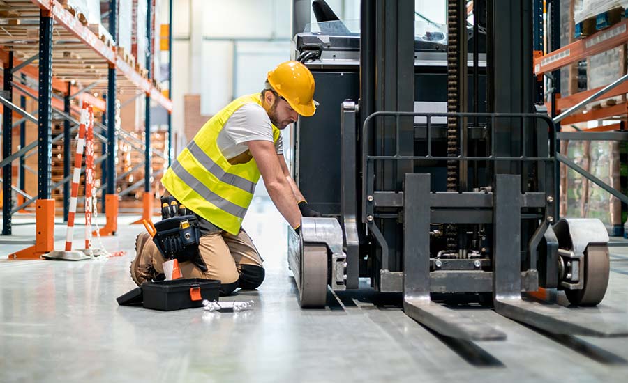 Predictive Maintenance - An image of a warehouse operator repairing a forklift