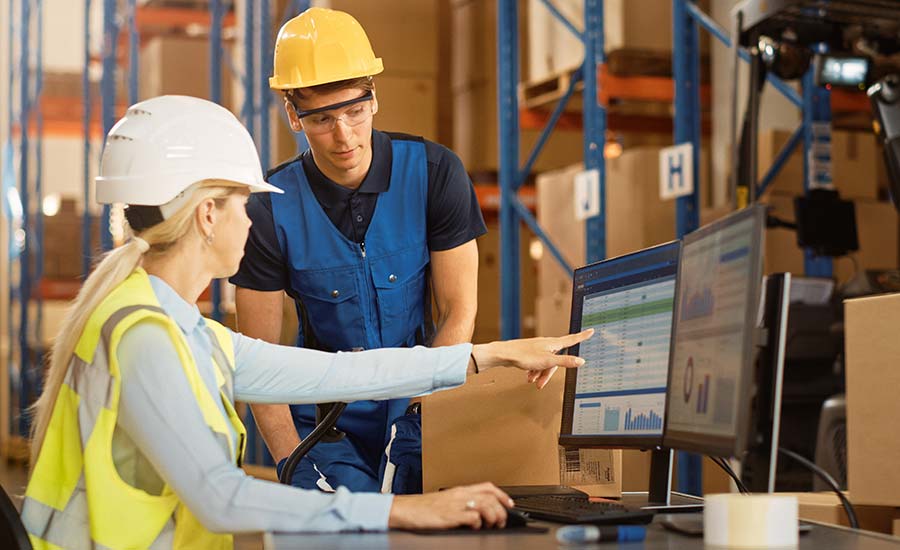 Two warehouse operators looking at a screen