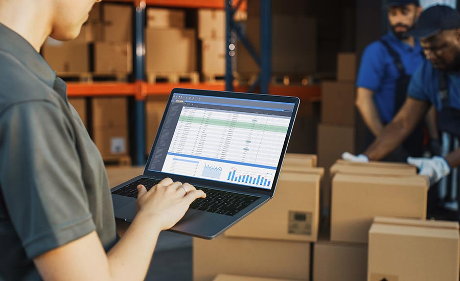 A female warehouse employee looking at inventory levels