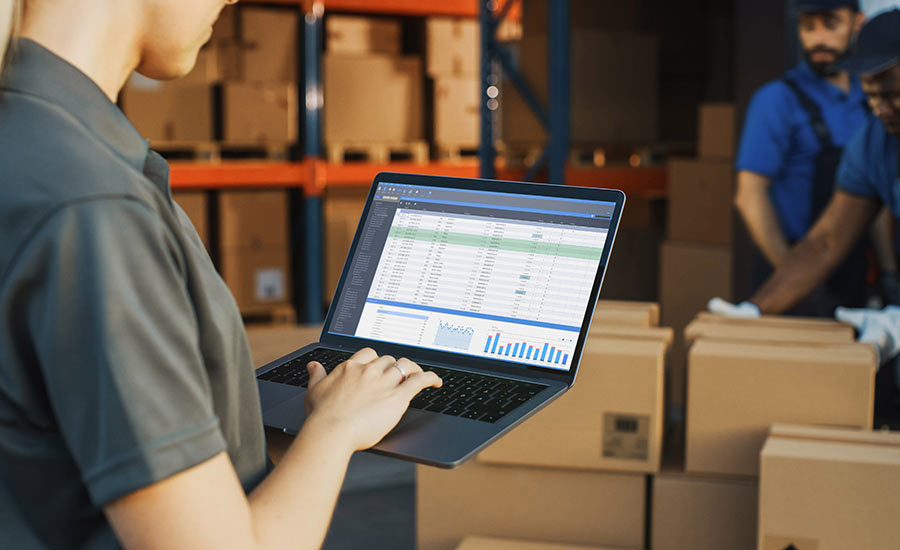 A female warehouse employee looking at inventory levels