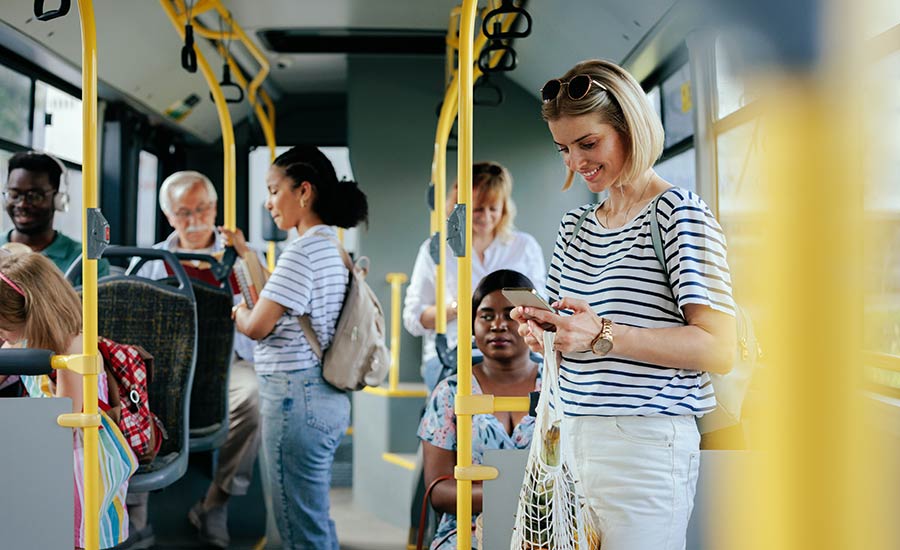 A young woman in a city bus after shopping for groceries