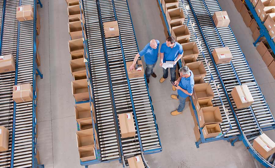 Warehouse employees sorting boxes on conveyor belts​