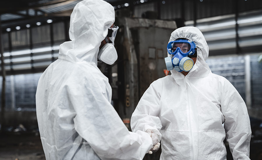 Two warehouse employees wearing personal protective equipment​