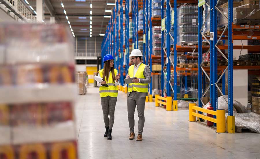 Two warehouse employees traveling throughout the warehouse​