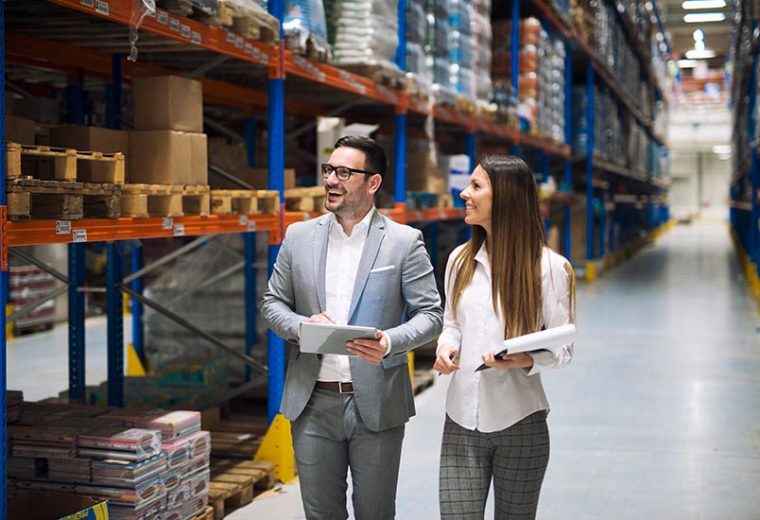 Two warehouse managers walking in a warehouse​