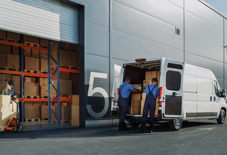 Warehouse employees loading packages into a truck